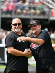Chuck and Jeff Lutz interact during the second drivers meeting.