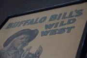 A classic American poster that reads "Buffalo Bill's Wild West," next to an illustration of Buffalo Bill. A classic American poster that reads "Buffalo Bill's Wild West," next to an illustration of Buffalo Bill.
