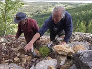 Mike McCann (L) and Stan Zuray (R) plant the tube of explosives Stan mixed into the mountain. They hope they can blow out the old entrance to the silver mine and gain access to the mine's tunnel.