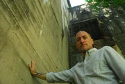 DACHAU, GERMANY - Steve Remy stands at a concrete structure in the Dachau Concentration Camp. DACHAU, GERMANY - Steve Remy stands at a concrete structure in the Dachau Concentration Camp.