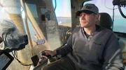 Shawn Pomrenke sits comfortably in the cabin of his excavator as he patiently looks for gold on the ocean floor.