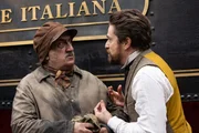 Niccolo Moretti (Giovanni Scifoni, r.) fleht den Zugführer (Alexandru Bindea, l.) an die Fahrt fortzusetzen, da sein Sohn Alberto dringend in ein Krankenhaus gebracht werden muss.