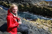Lydia Hallis analyzing a rock sample on the Isle of Staffa, Scotland.