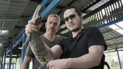 YANGON, MYANMAR - Sam and Robert Joe get up close and personal with a baby man-eating crocodile, which can grow to three times the height of a human.