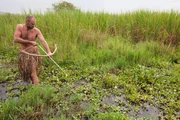 Rwanda, Akagera National Park. Ed hunting with his self-made bow and arrow. Rwanda, Akagera National Park. Ed hunting with his self-made bow and arrow.