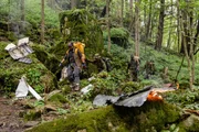 Ony Wibowo (played by Xavier de Guzman) and marines (played by background performers) navigate their way through the forest around the wreckage from the Sukhoi Superjet air crash on Mount Salak, Indonesia.