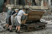 Die "Trümmerfrauen" müssen Tonnen von Schutt in Loren laden. Sogenannte Trümmerbahnen bringen ihn auf die riesigen Halden am Stadtrand.