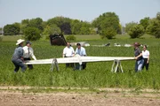 Binbrook, Ontario, Canada: Reenactment. Joshi and Ritter help place the broken tail section from Continental Express Flight 2574 onto two wooden sawhorses. Its distance from the main wreckage suggests it was one of the first pieces to fall from the plane before it plunged nearly 20,000 feet to the ground, killing everyone on board. Investigators discover that a crucial piece of the horizontal stabilizer is missing, and the screws meant to hold it in place look as if they were not inserted.