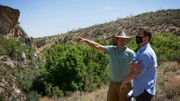 Eric Drummond points an area of land out to the Producer.