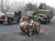 Vintage jeeps and bikes lined up and ready for the Battle of the Bulge reenactment.