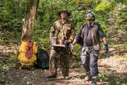 Ony Wibowo (played by Xavier de Guzman) and a marine (played by background performer) recover debris from the wreckage of the Sukhoi Superjet demonstration flight crash on Mount Salak, Indonesia.