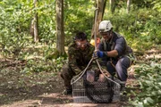 Lincoln, Ontario - Ony Wibowo (played by Xavier de Guzman) and a marine (played by background performer) load the recovered black boxes from the Sukhoi Superjet demonstration flight crash into a basket before they are taken for analysis.