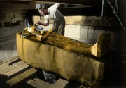 Howard Carter brushing dust off King Tut's mummy. Howard Carter brushing dust off King Tut's mummy.