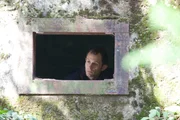 Patrick Bury looking through one of the concrete fortifications of the Siegfried Line.