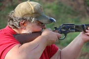 Larry Harley holding a rifle. Larry Harley holding a rifle.
