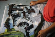 DANAO, PHILIPPINES- Edwin presents various styles of guns. DANAO, PHILIPPINES- Edwin presents various styles of guns.