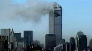 Manhattan, New York: Wide shot of the World Trade Center on fire after an airliner flew directly into it.