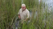 The Okavango Delta, Botswana. Dave Canterbury wading through the hippo grass.