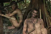 Kim and Shane resting in their shelter they built.