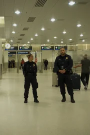 Miami, FL - Officers Pupo and Rimola stand guard near the exit.