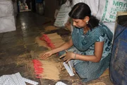 Woman stacking incense sticks. Woman stacking incense sticks.