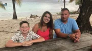 Clients Ryan Bilyk & Sarah Tofflemire pose with their son Chris on the beach in Utila, Honduras. As seen on HGTV's Caribbean Life.