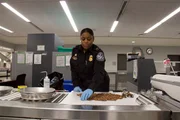 Officer Arrisia Sima inspects commodity for potential pests. Officer Arrisia Sima inspects commodity for potential pests.