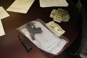 Agents document evidence found during a traffic stop: bullets, a handgun, and cash. (National Geographic/Lucky 8 TV) Agents document evidence found during a traffic stop: bullets, a handgun, and cash. (National Geographic/Lucky 8 TV)