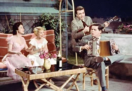 Ralf (Claus Biederstaedt, hinten) und Charely (Walter Giller) heizen den h&uuml;bschen Touristinnen Ulla (Elisa Loti, 2. von rechts) und Britta (Ina Peters) m&auml;chtig ein.