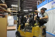 Jose driving forklift in warehouse.