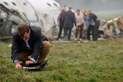 REENACTMENT - Surviving passenger of Ansett New Zealand Flight 703 William McGrory (played by Benjamin James) searches for his cell phone among the debris to call for help.