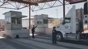 CBP officers stop a semi truck for inspection on the Mexican border. (National Geographic)