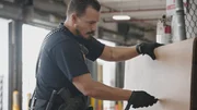 Officer Hernandez cuts open cardboard for any unexpected anomalies. (National Geographic)