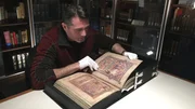 Rob examines ancient Irish text in the Book of Kells. Rob examines ancient Irish text in the Book of Kells.