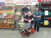 Amanda clips coupons with her husband and parents.