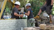 Chris "Crash" Warren and Jane Werley placing a rock.