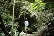 Geologist Dr. Duncan Cook (Australian Catholic University) at the mouth of a cave used by the ancient Maya for sacred rituals, recently revealed by a new LiDAR treasure map at the ancient Maya city of El Zotz in northern Guatemala.