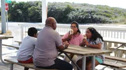Contributors Arun Raju (CL) and Becky Thomas (CR) enjoy some ice cream with their children Matthew (L) and Rayna (R) in between touring condos in Panama City Beach, Florida, as seen on HGTV's Beachfront Bargain Hunt.