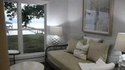 The sitting room in the master bedroom of Bel Aire Bayhouse has incredible views of Mobile Bay, as seen on HGTV's Beachfront Bargain Hunt. The sitting room in the master bedroom of Bel Aire Bayhouse has incredible views of Mobile Bay, as seen on HGTV's Beachfront Bargain Hunt.
