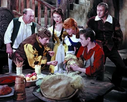 Die Bande um Prinz St&ouml;renfried will die Prinzessin entf&uuml;hren und hat zuvor Halt beim Wirt (Fritz Schlegel, ganz links) gemacht. Der Schuster Klaus (Kaspar Eichel, vorne ganz rechts, mit Gans) und die beiden Wirtst&ouml;chter Lies (Katharina Lind, vorne 2.v.re.) und Gret (Renate Usko, 3.v.re.) wollen die St&ouml;renfriede daran hindern. Klaus versucht den Schreihals  (Joachim Fuchs, vorne 2.v.li.) zu locken, dass er die Goldene Gans anfasst und an ihr kleben bleibt.