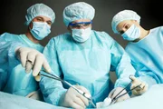 Three surgeons working operation against dark background Three surgeons working operation against dark background