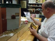 Sesame Street Cake. Mauro works on constructing the exterior buildings of the Sesame St cake.