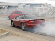 Tina Pierce's red sportscar along with Justin's truck.