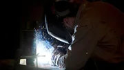 Welding with bright sparks flying.