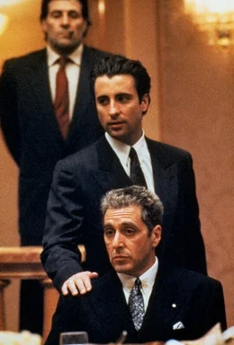 Vincent Mancini-Corleone (Andy Garcia, hinter) und Don Michael Corleone (Al Pacino, vorne) bei einer Versammlung der Familien