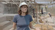 Eine Frau mit Schutzhelm und Brille steht im Vordergrund einer archäologischen oder restauratorischen Baustelle. Sie trägt ein helles Hemd und scheint Teil eines Expertenteams zu sein, das an der Erhaltung oder Erforschung des Tempelkomplexes Angkor Wat beteiligt ist. Im Hintergrund sind weitere Personen und Bauelemente zu sehen. Die Szene vermittelt den professionellen Einsatz moderner Technik zur Bewahrung antiker Megastrukturen. Eine Frau mit Schutzhelm und Brille steht im Vordergrund einer archäologischen oder restauratorischen Baustelle. Sie trägt ein helles Hemd und scheint Teil eines Expertenteams zu sein, das an der Erhaltung oder Erforschung des Tempelkomplexes Angkor Wat beteiligt ist. Im Hintergrund sind weitere Personen und Bauelemente zu sehen. Die Szene vermittelt den professionellen Einsatz moderner Technik zur Bewahrung antiker Megastrukturen.