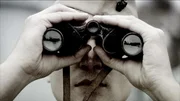 Pearl Harbor, Hawaii, USA: Drama Reconstruction; Man with binoculars looking at attack on Pearl Harbor.