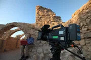 Caesarea, Israel - Barrie Wilson on phone/laptop looking for hidden Christian texts that could be proof that Mary was Jesus' wife, on the phone to Margaret Starbird.