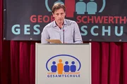 Obwohl Stefan Vollmer (Hendrik Duryn) von der Schulamtsmitarbeiterin Mai ein Manuskript bekommen hat, h&auml;lt er seine eigene Rede.