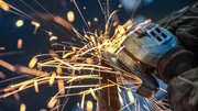 Sparks from an African man grinding metal